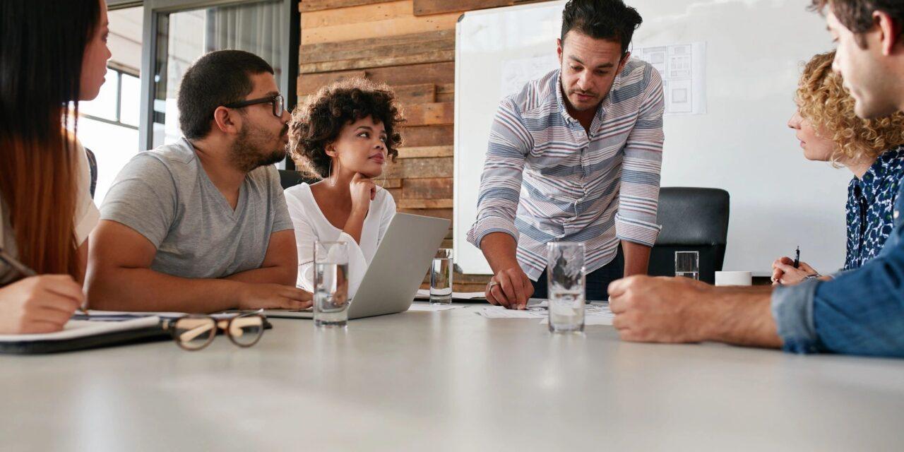 Staffing entrepreneurs brainstorm at a conference table