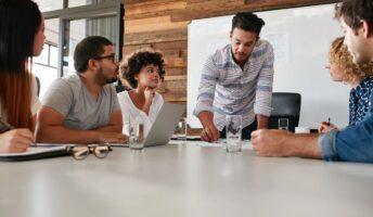 Staffing entrepreneurs brainstorm at a conference table